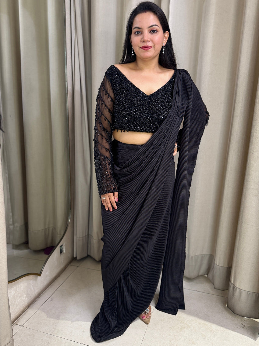 Black drape saree with heavy hand embroidered net blouse and imported  pleated fabric of saree.