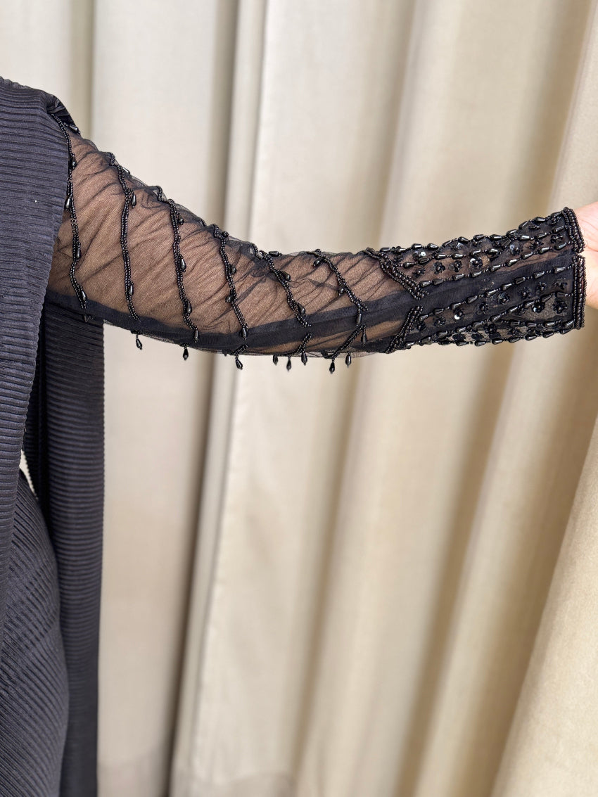 Black drape saree with heavy hand embroidered net blouse and imported pleated fabric of saree.