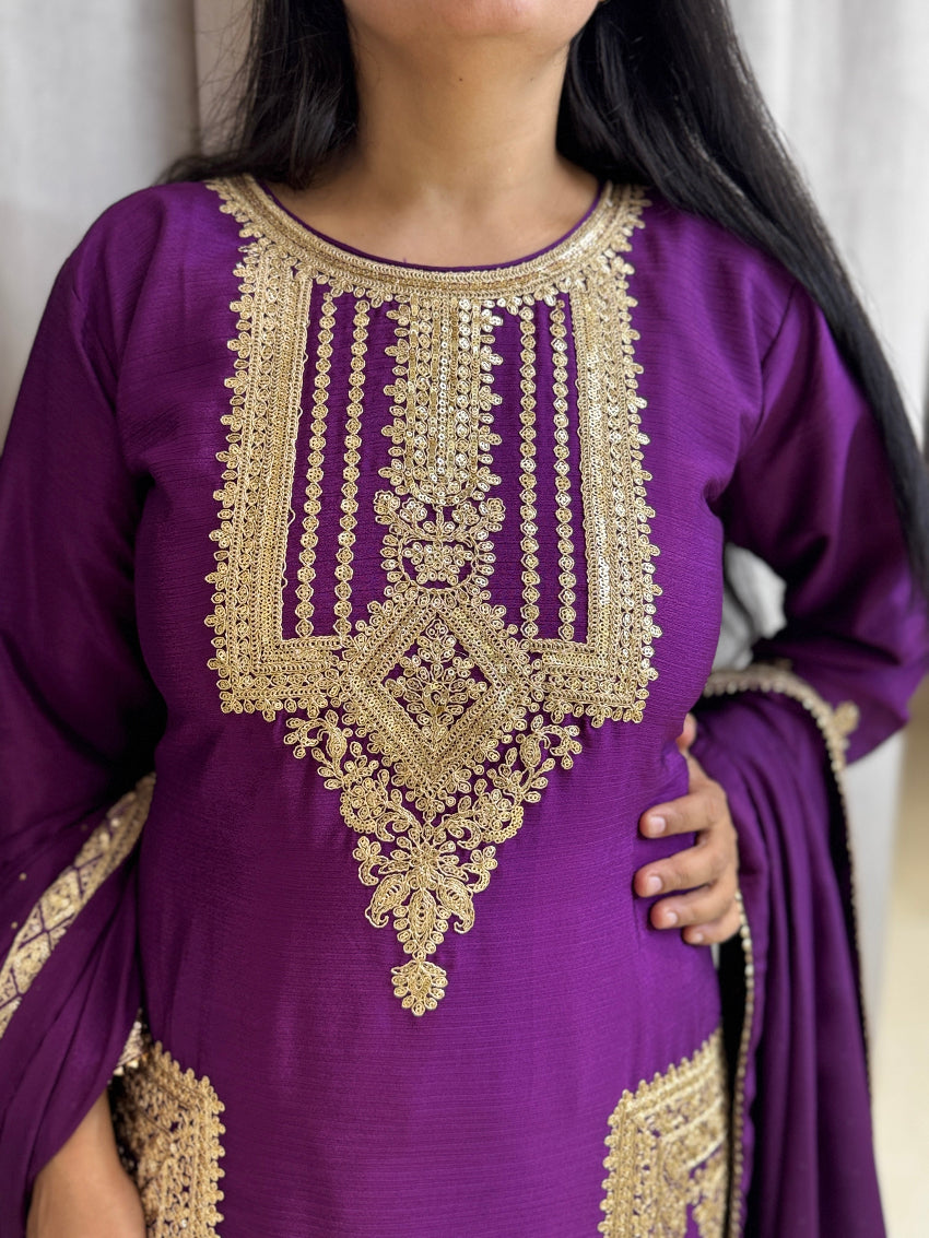 Purple outfit with gold embroidery on a plain background