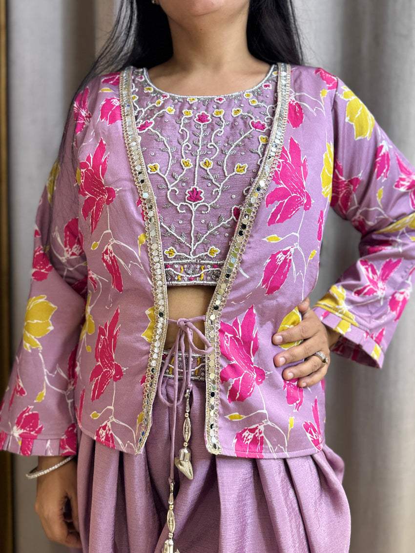 Person wearing a pink floral outfit with intricate designs against a neutral background