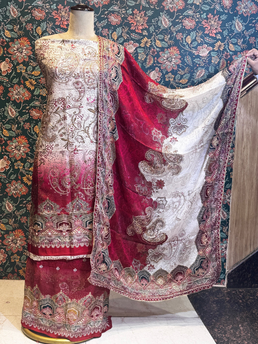Embroidered traditional outfit on a mannequin against a floral wallpapered wall.
