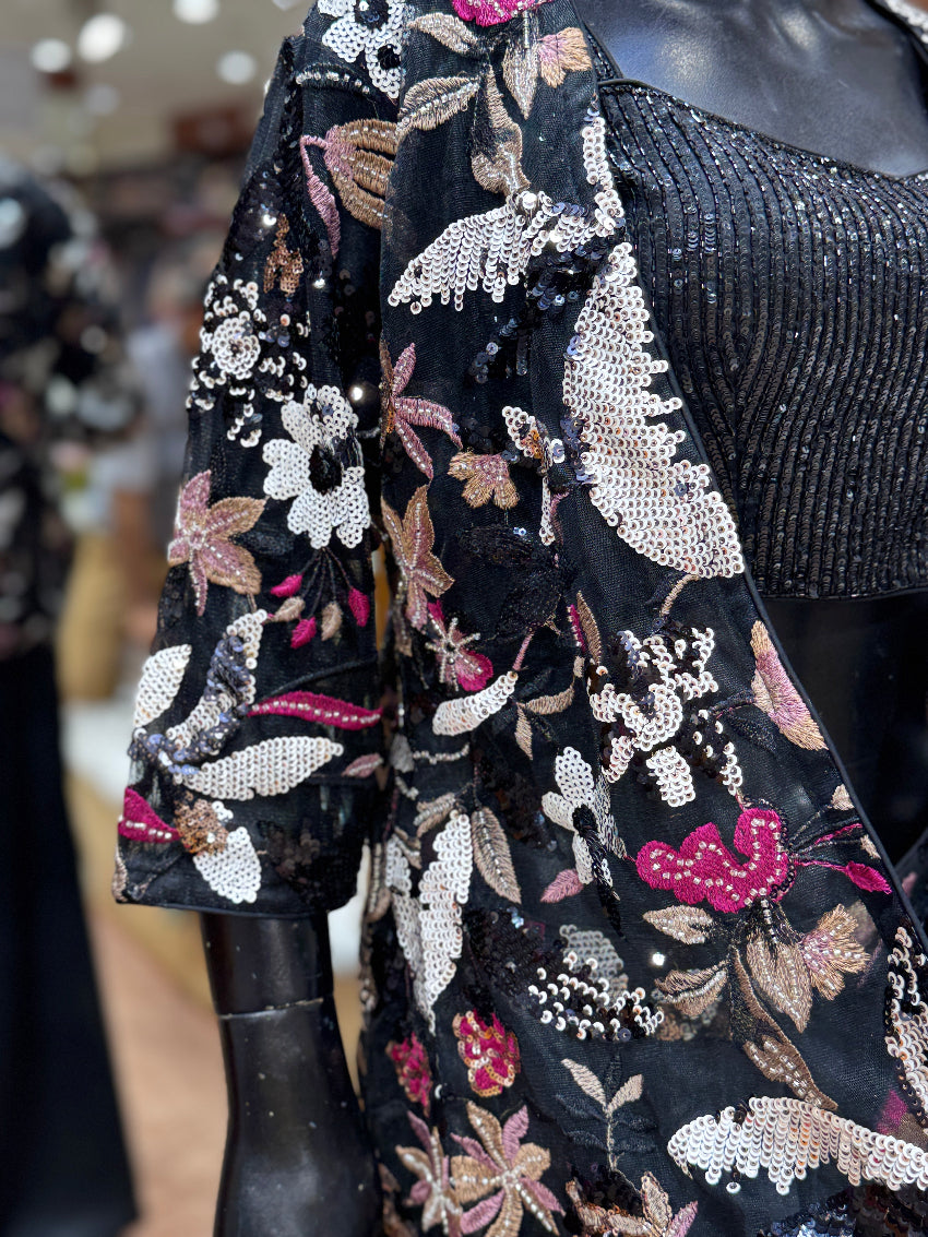 Black floral embroidered jacket with sequins on a blurred background