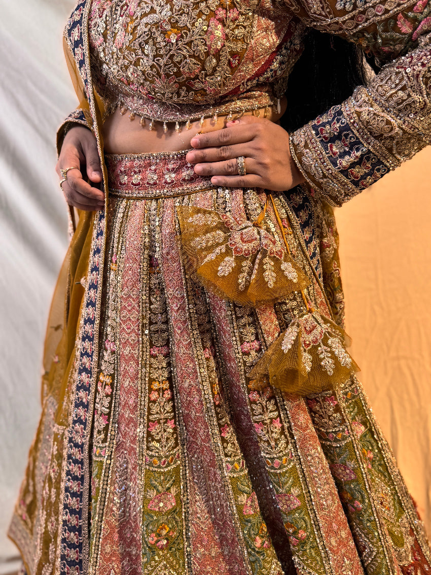 Traditional embroidered outfit with intricate patterns on a plain background