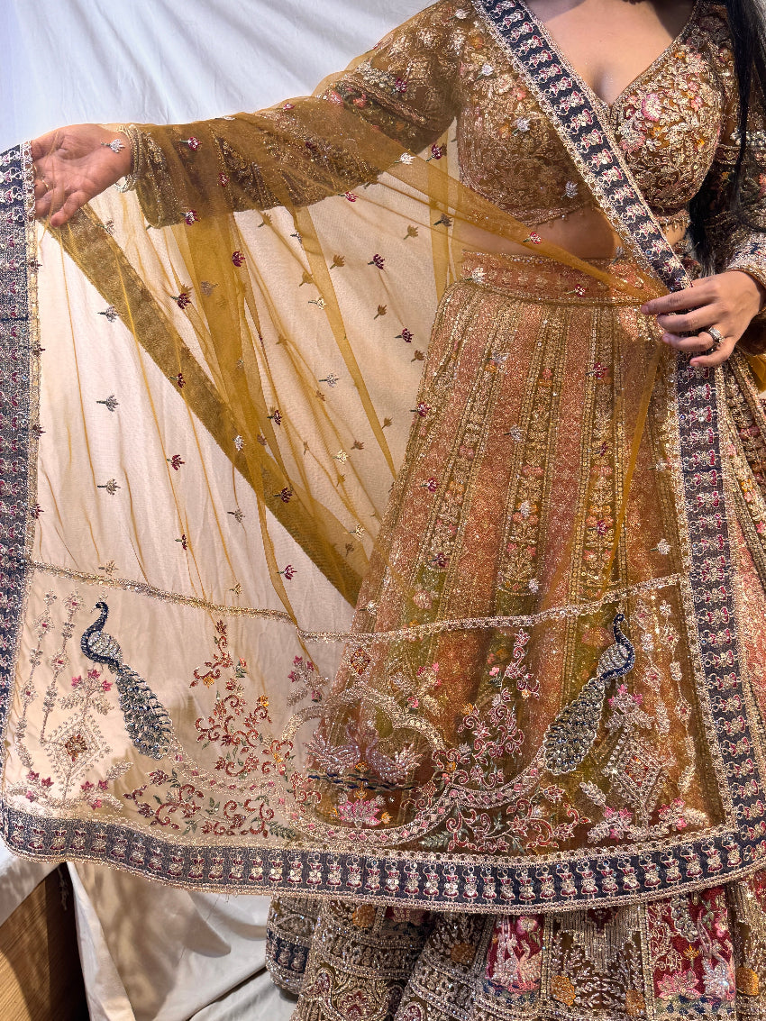 Person holding a piece of intricately designed fabric with floral patterns.