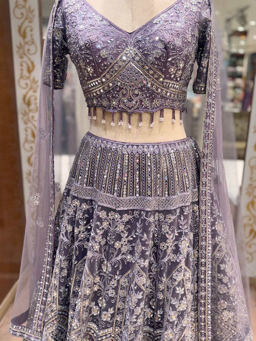 Decorative traditional outfit with intricate patterns on a mannequin.