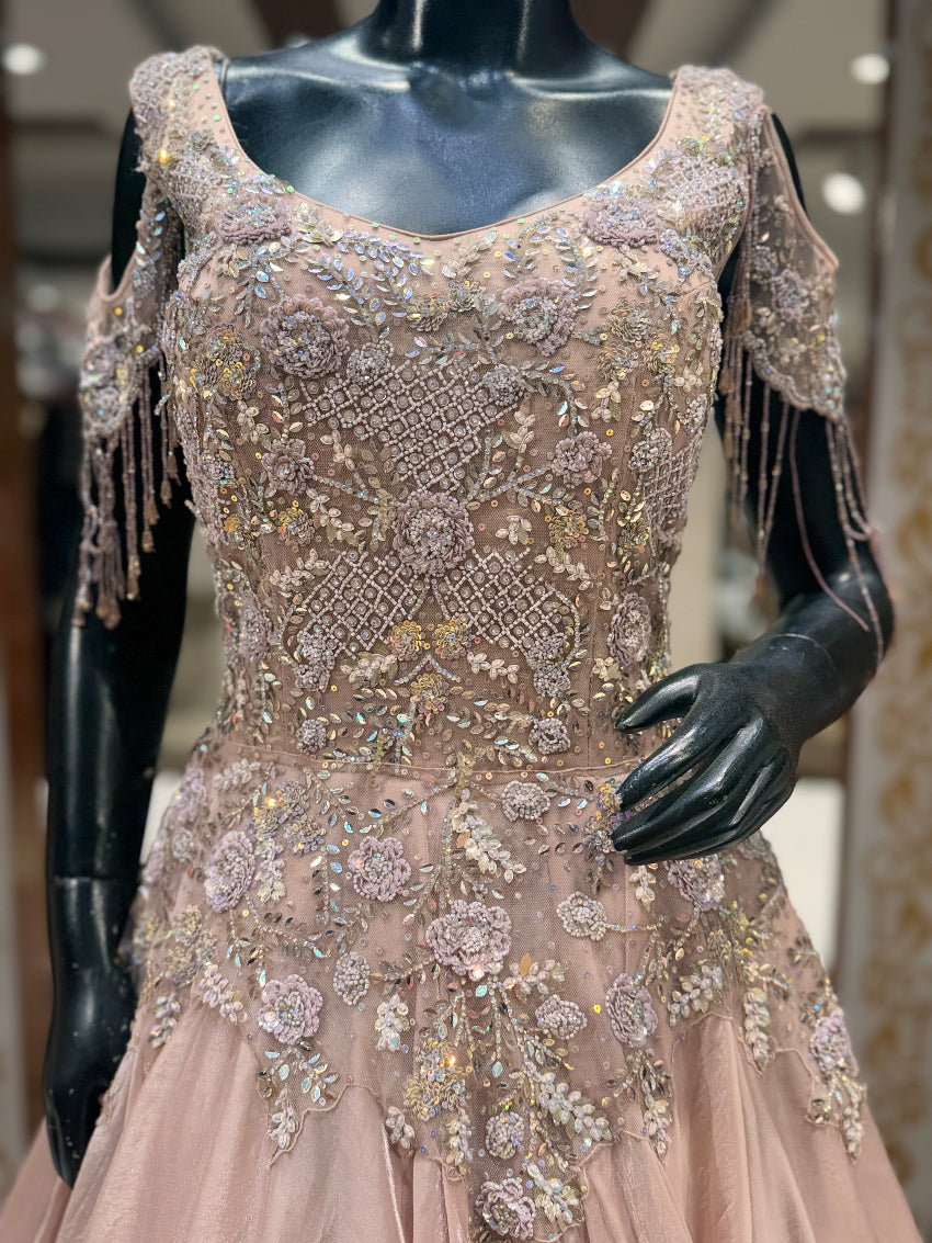 Elegant dress with intricate beading and fringes on a mannequin.