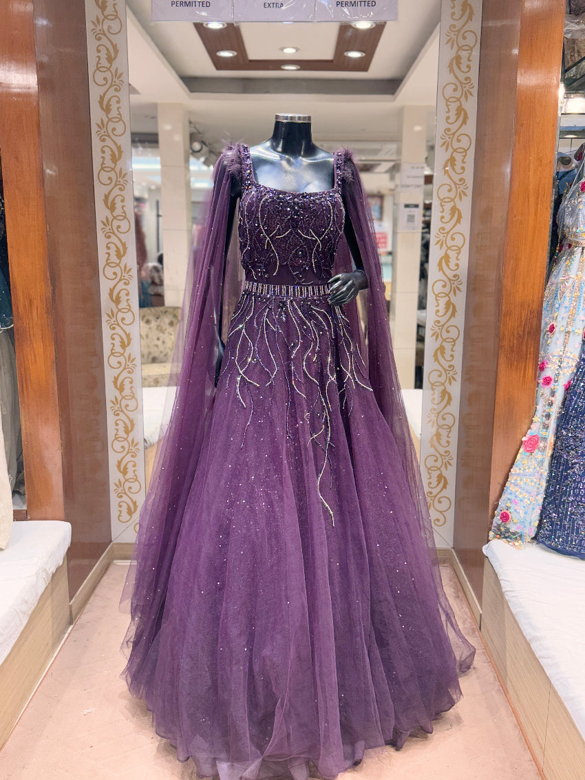 Purple evening gown with cape on a mannequin in a store setting