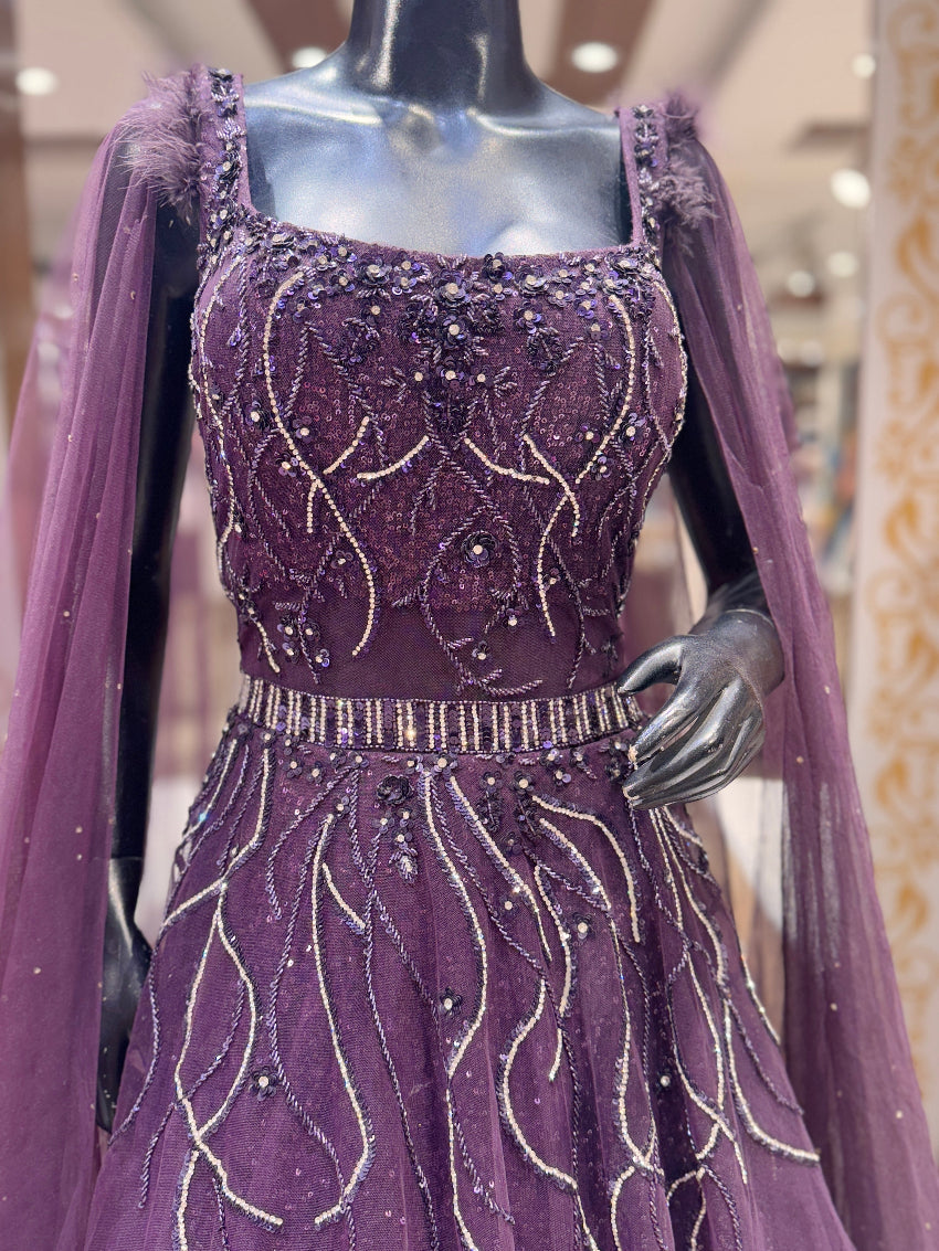 Purple evening gown with intricate beading on a mannequin