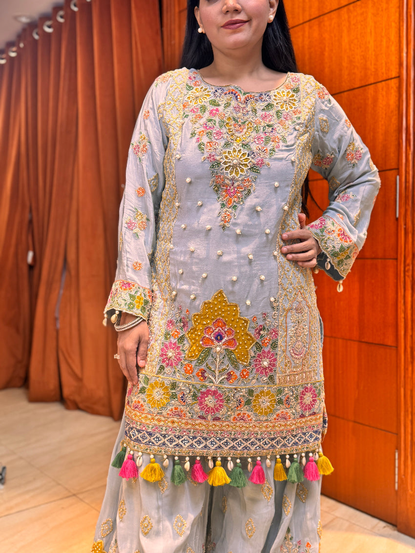 Powder blue hand embroidered designer sharara suit with multi colored cut work dupatta