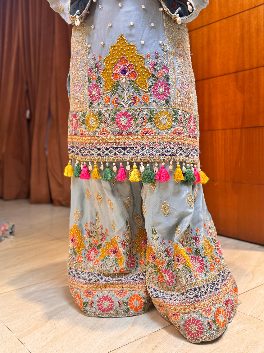 Powder blue hand embroidered designer sharara suit with multi colored cut work dupatta