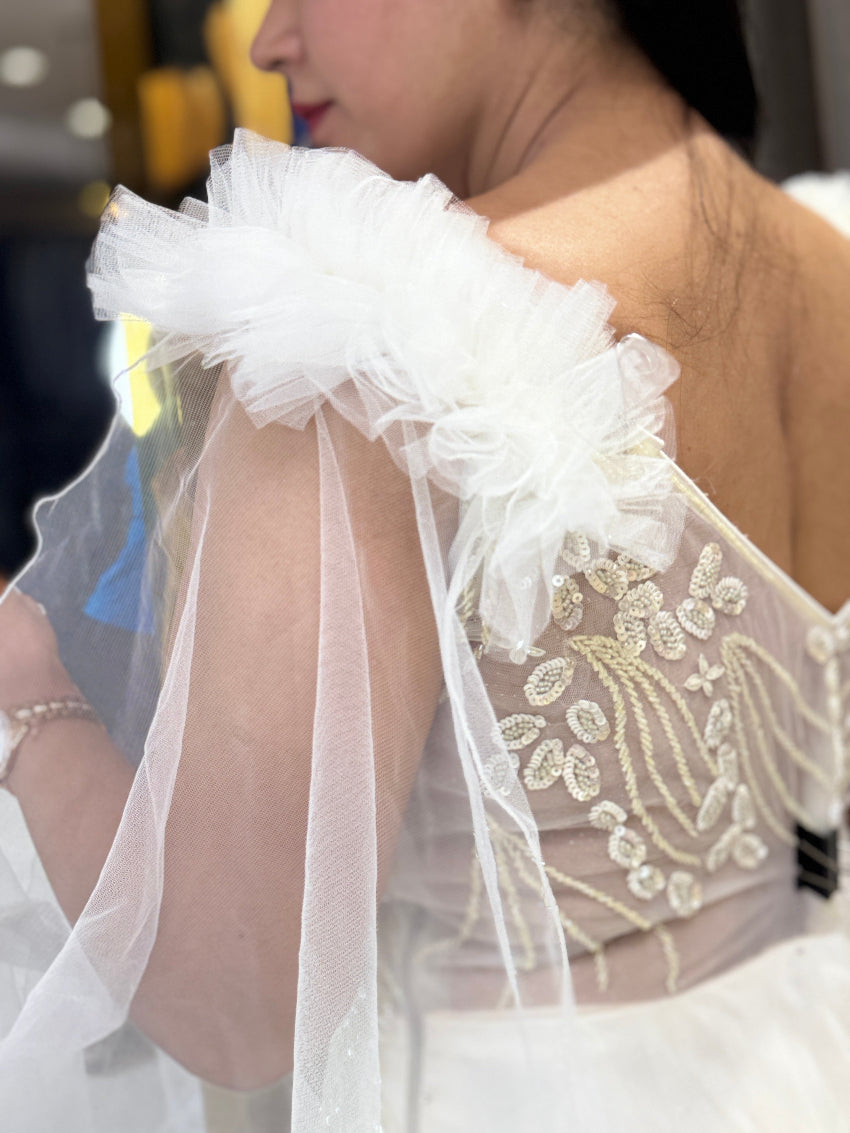 Ivory ball gown with designer hand embroidery and long net cape sleeves with frill shoulder