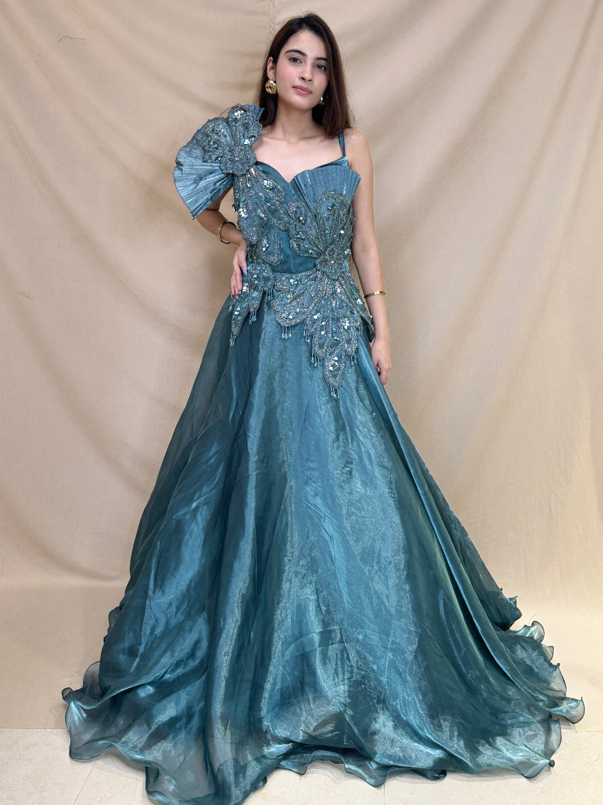 Turquoise Blue party wear gown in cosmos fabric and detailed with stones, cutdana and sequin.