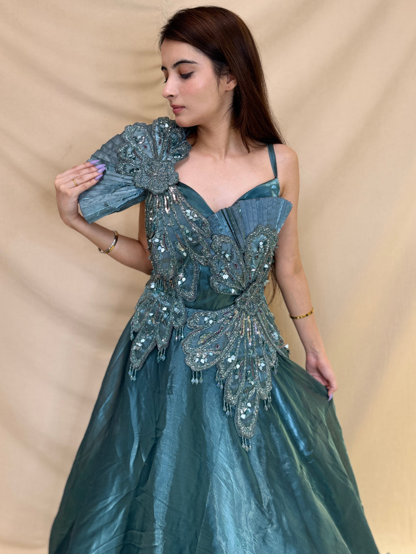 Turquoise Blue party wear gown in cosmos fabric and detailed with stones, cutdana and sequin.