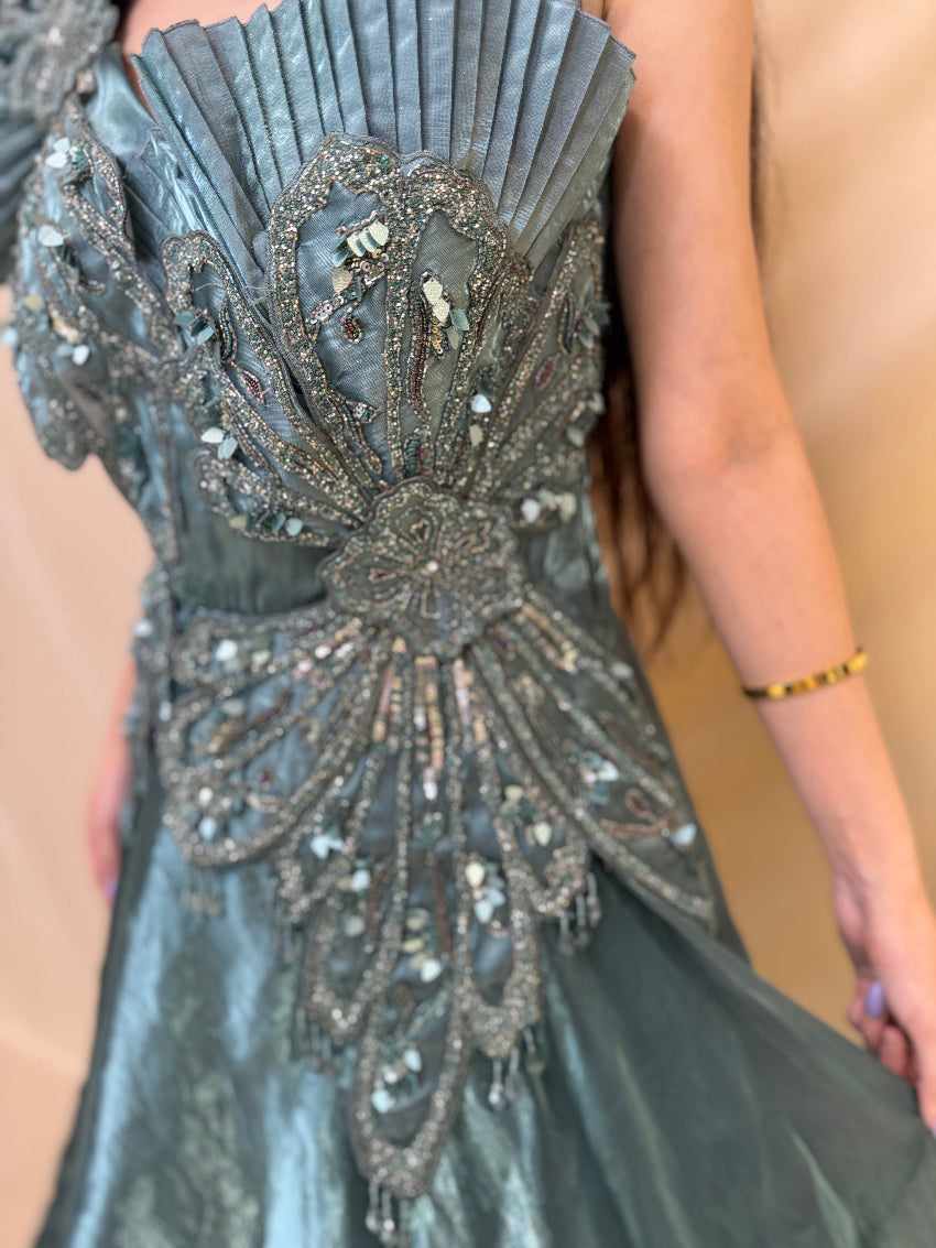 Turquoise Blue party wear gown in cosmos fabric and detailed with stones, cutdana and sequin.