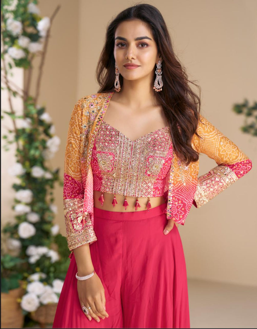 Woman wearing a pink traditional outfit with a yellow jacket against a neutral background