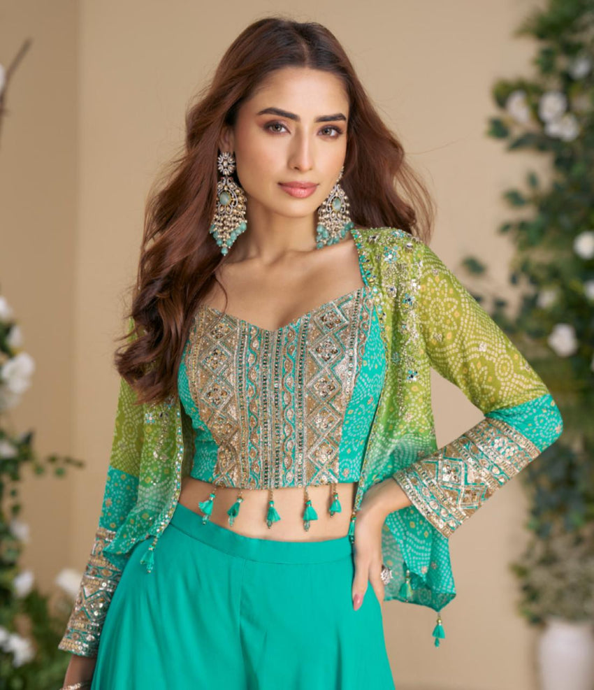 Woman wearing a traditional outfit with green and gold details against a neutral background