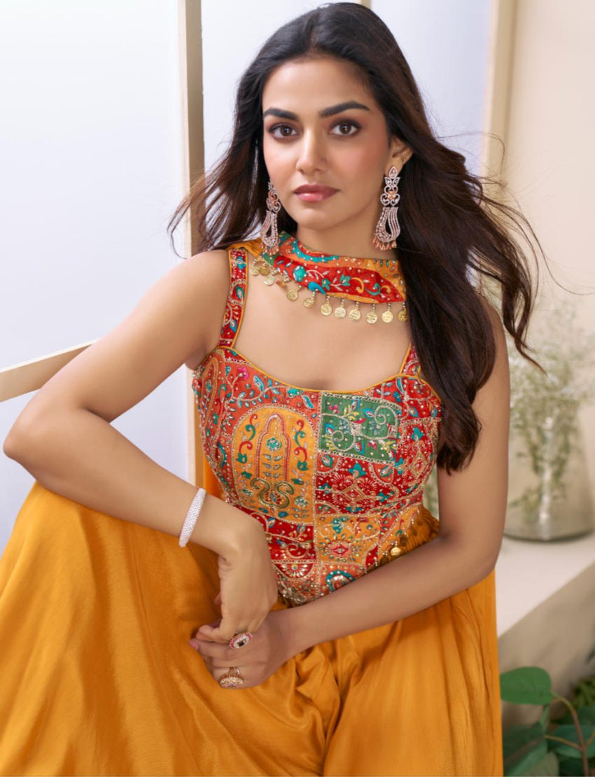 Woman wearing a colorful traditional outfit with a vibrant top and yellow skirt.