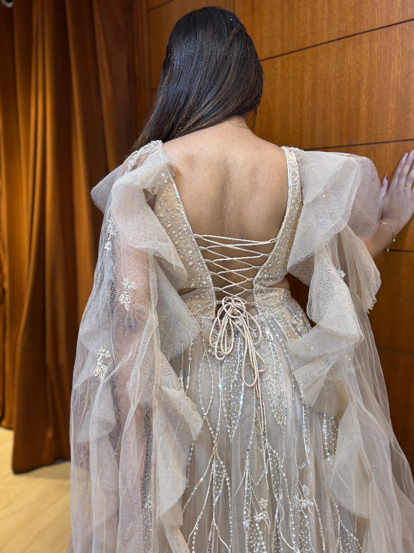 Champagne gold premium hand-embellished engagement gown with ruffle cape style sleeves and rope tie backless pattern