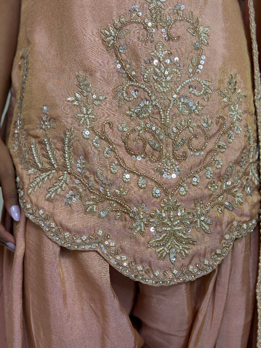 Close-up of a brown garment with intricate gold embroidery