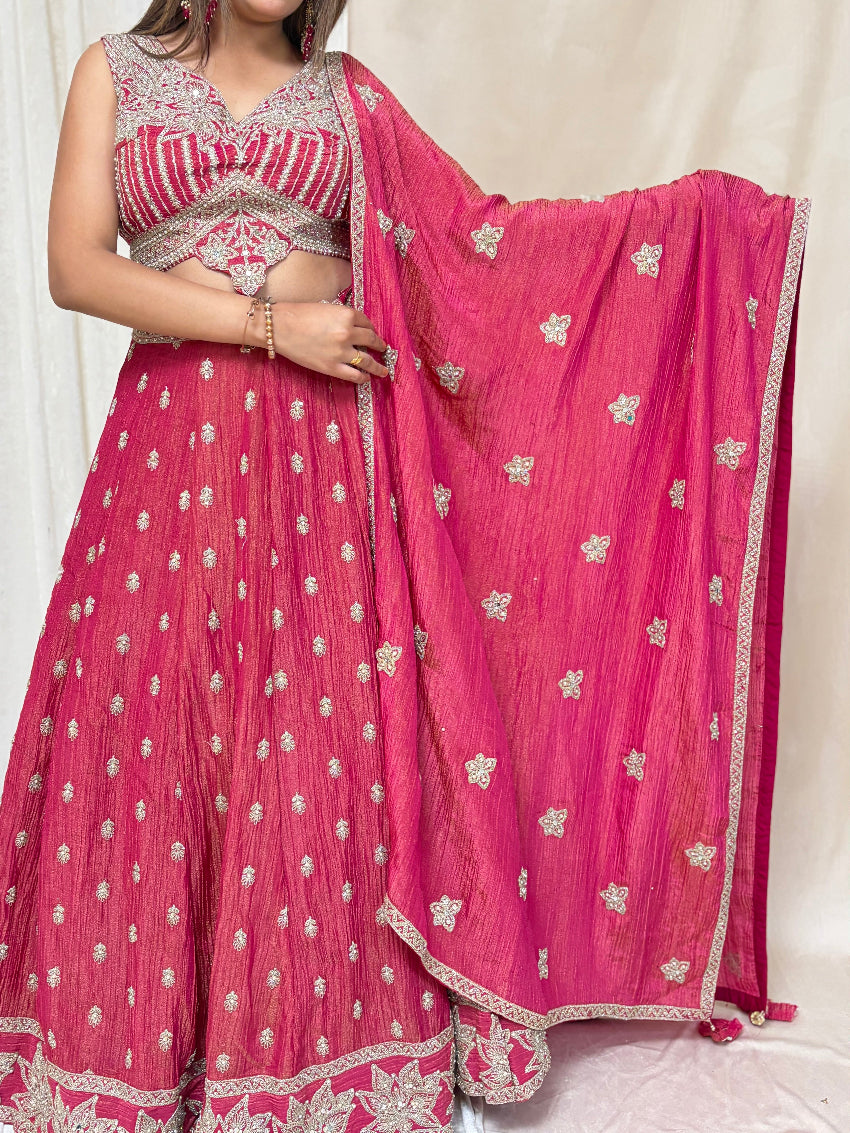 Pink traditional outfit with silver embroidery on a white background