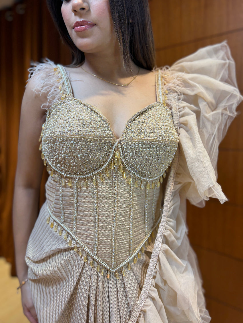 Woman wearing a beaded and ruffled dress with a neutral background