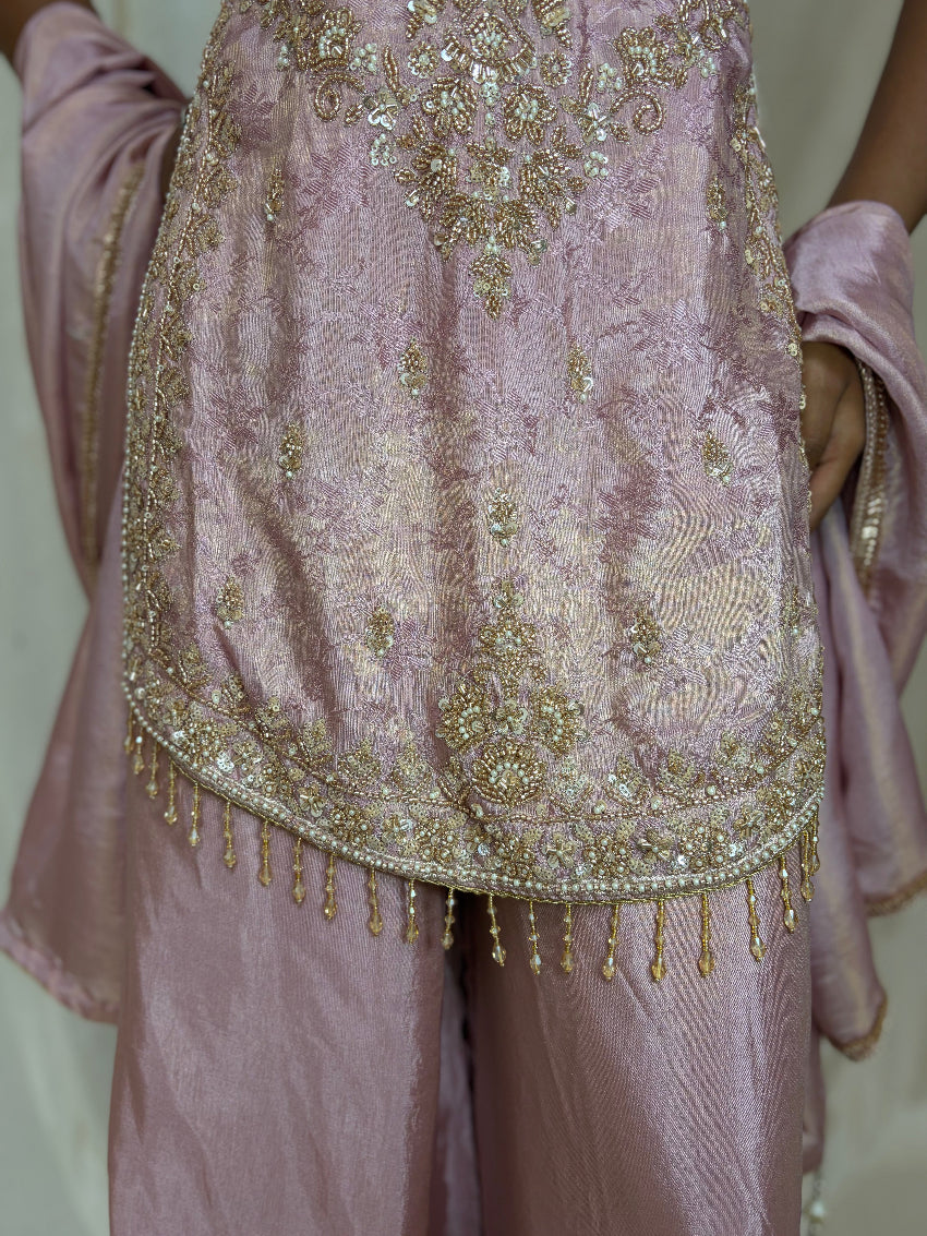 Light purple traditional outfit with intricate gold embroidery and embellishments.