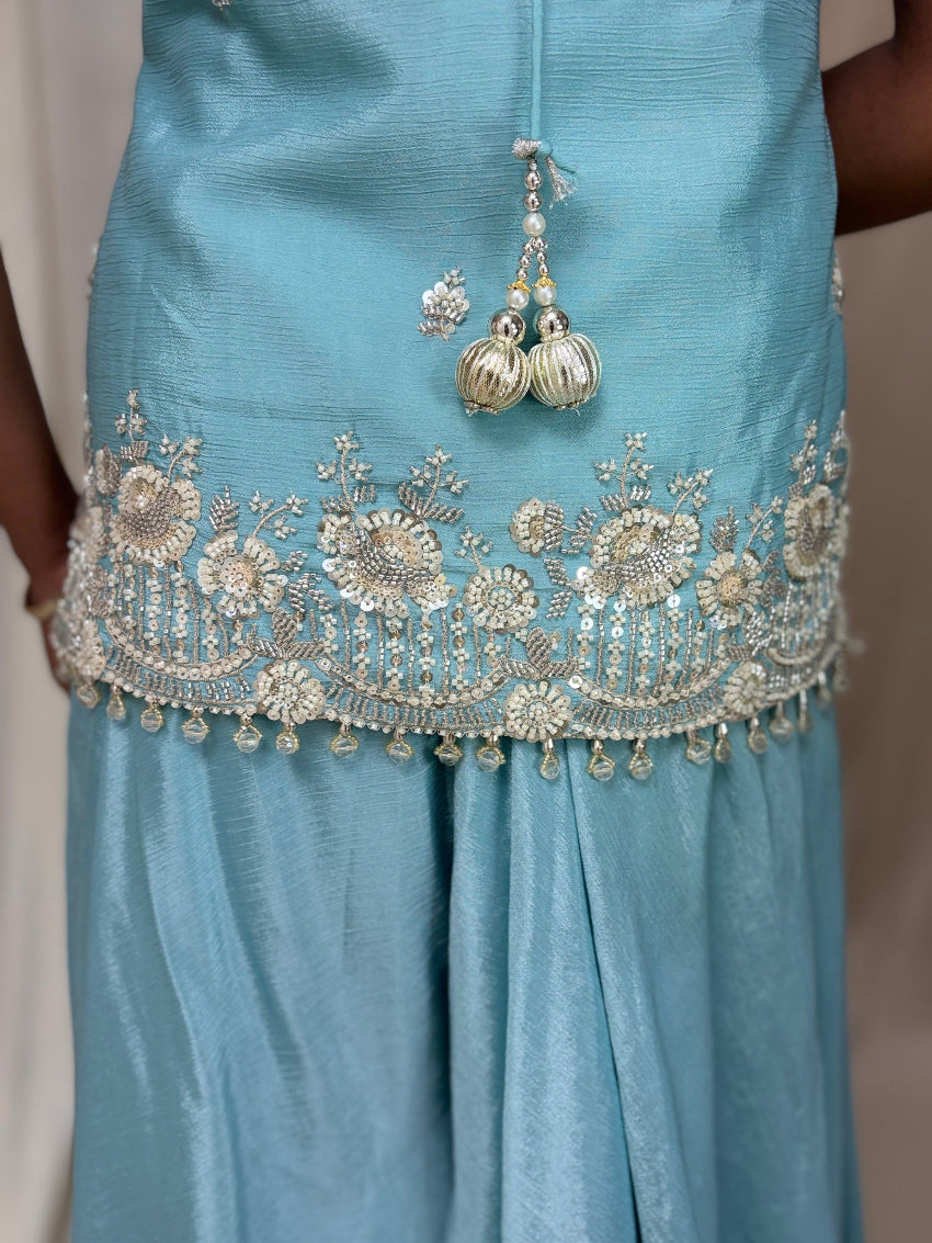 Light blue dress with intricate silver embroidery and embellishments.