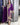 Woman wearing a purple traditional outfit with gold embroidery in a store setting.