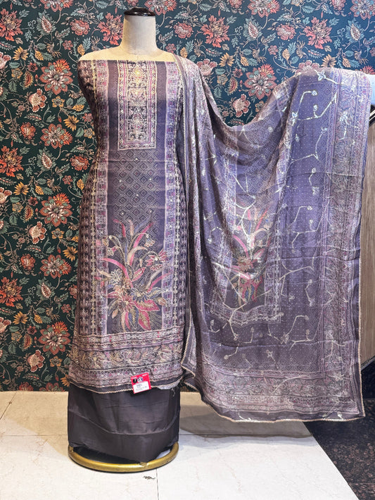 Traditional outfit with floral patterns on a mannequin against a floral wallpapered wall.