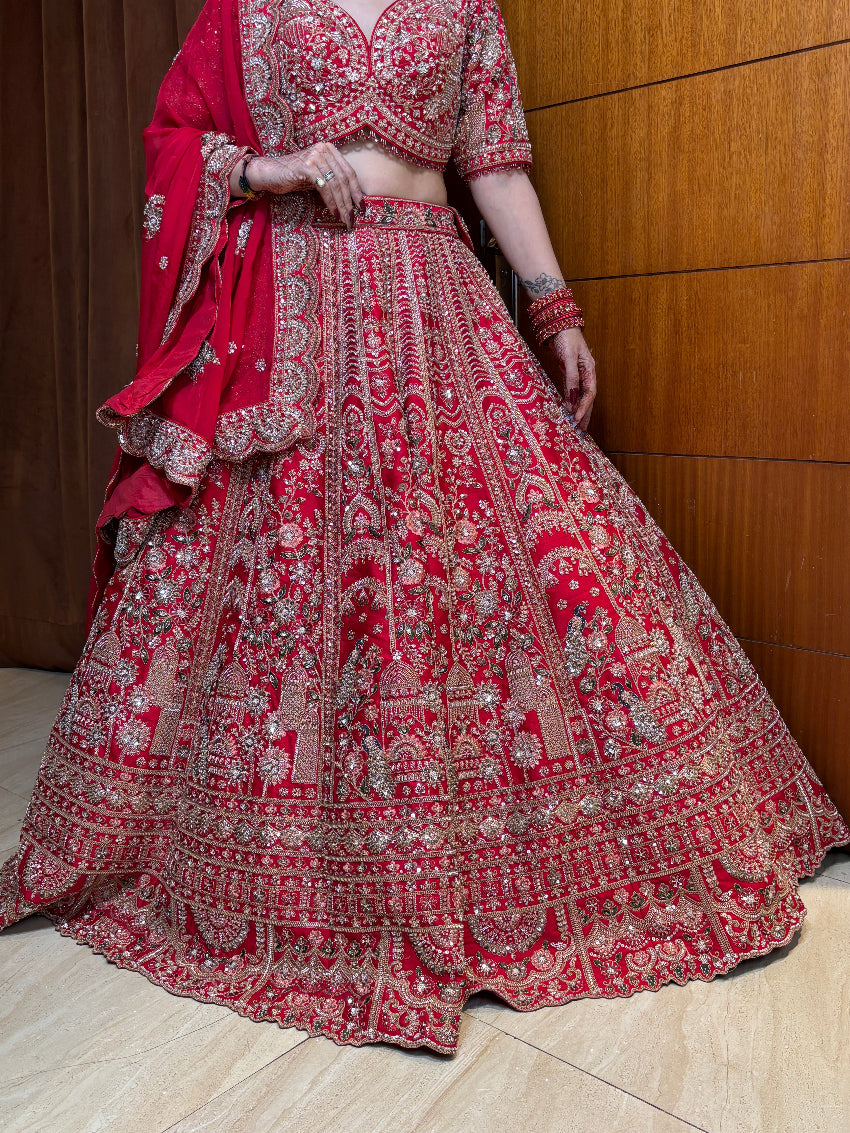 Red embroidered traditional outfit on a wooden floor