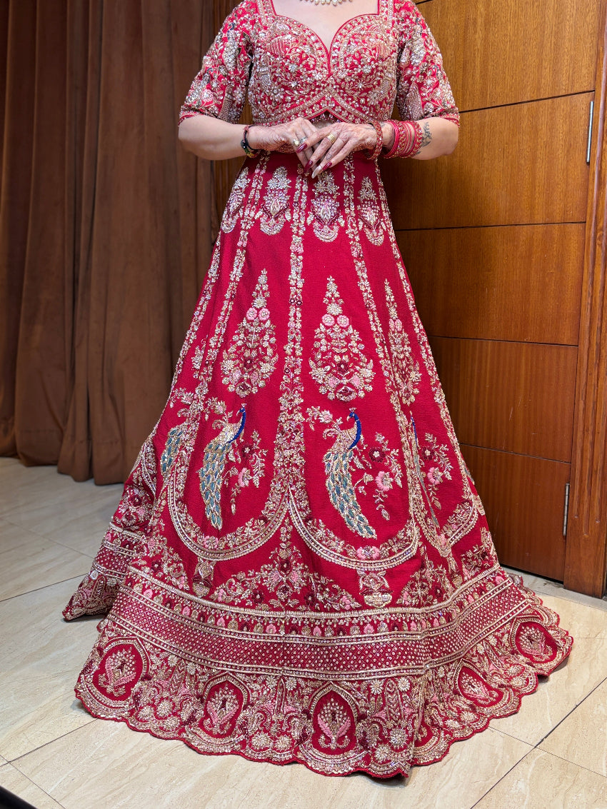 Red embroidered traditional dress on a wooden floor