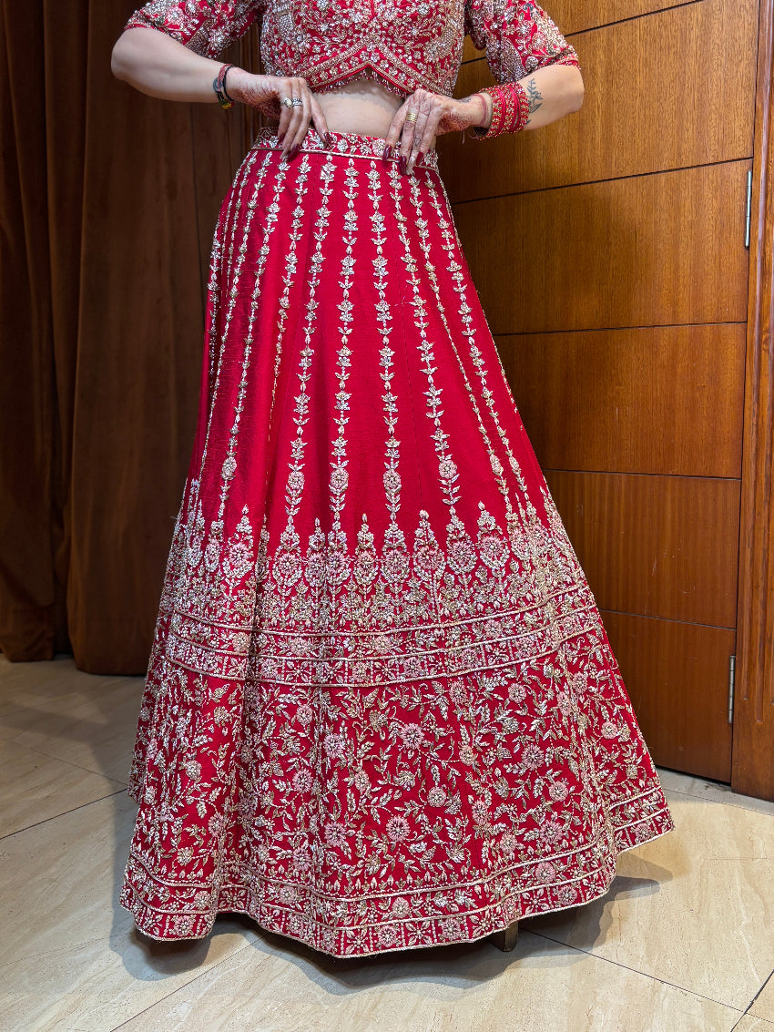 Red traditional outfit with white patterns on a wooden background