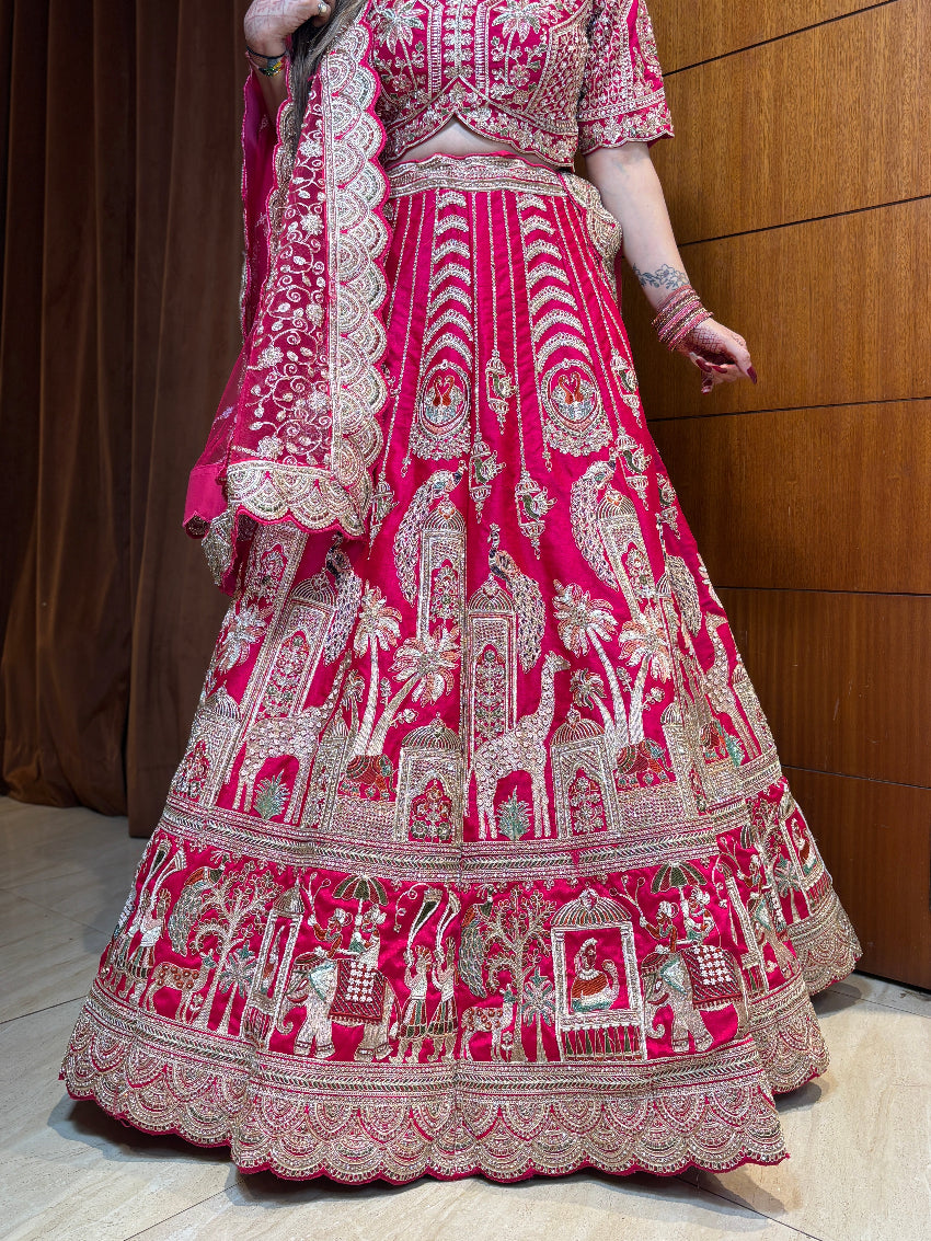 Traditional pink and white embroidered outfit on a wooden floor.