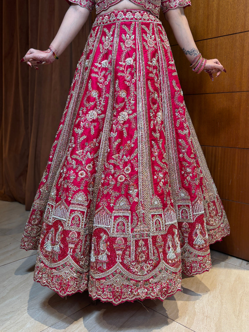 Red and white embroidered traditional outfit on a wooden floor.