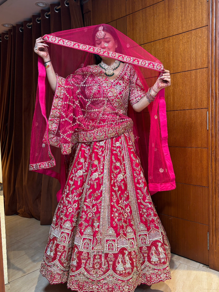 Person wearing a traditional pink and white embroidered outfit with a matching dupatta.