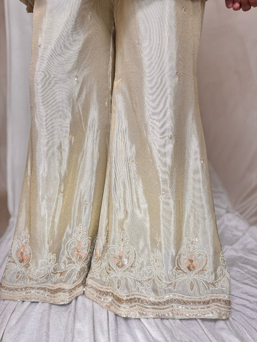 Beige embroidered traditional outfit on a white background