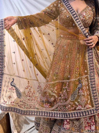Person holding a piece of intricately designed fabric with floral patterns.