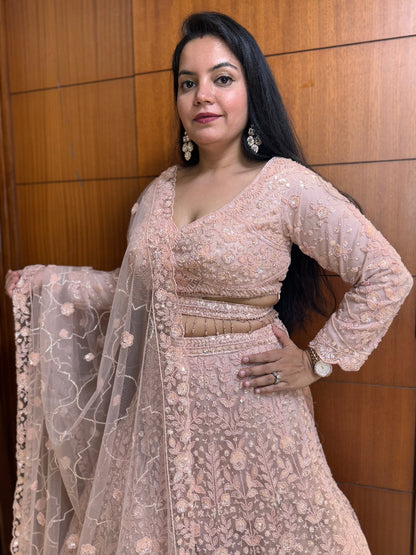 Woman wearing a traditional embroidered outfit with a wooden panel background