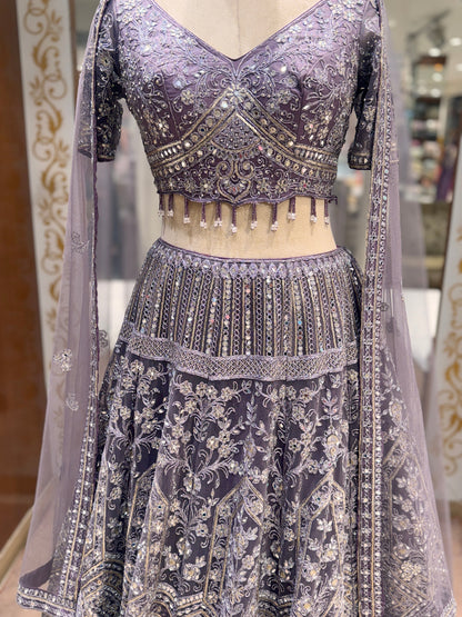 Decorative traditional outfit with intricate patterns on a mannequin.