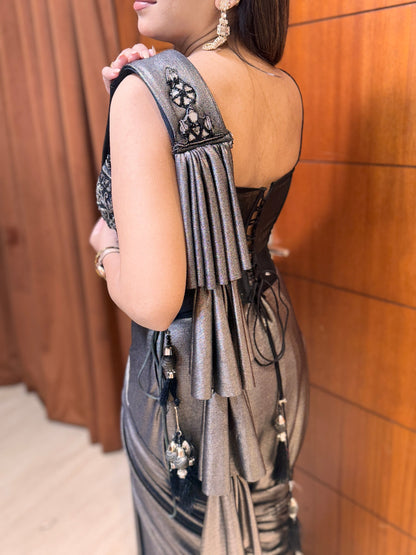 Woman wearing a metallic dress with intricate designs and embellishments.