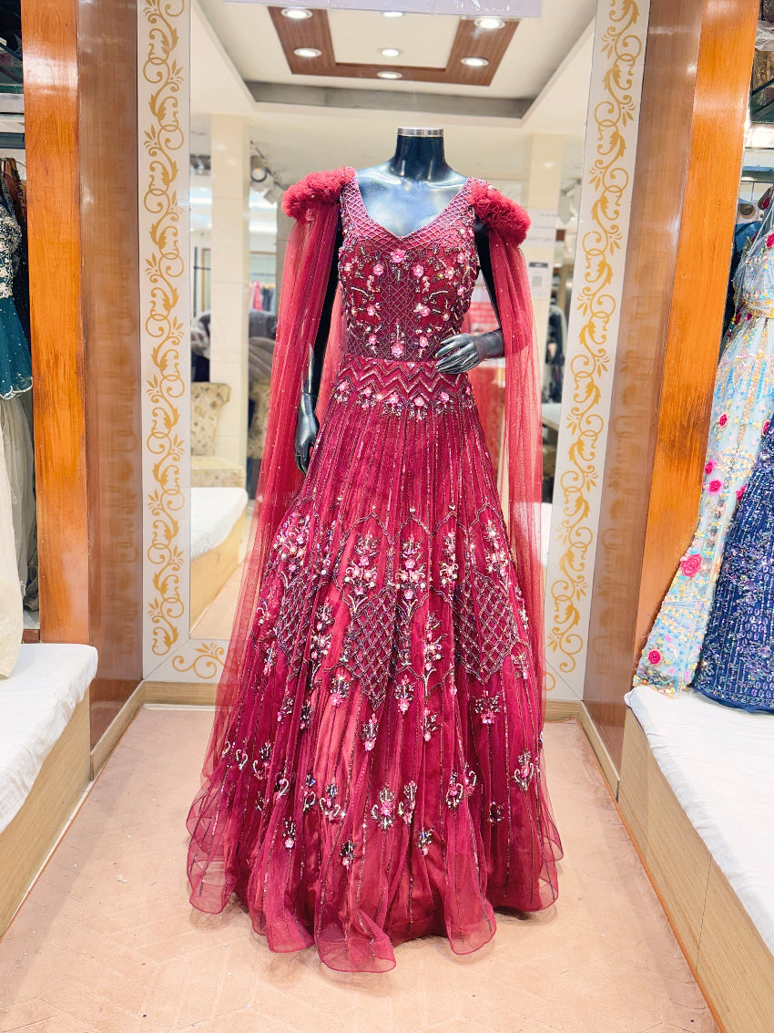 Red embroidered evening gown on a mannequin in a store setting