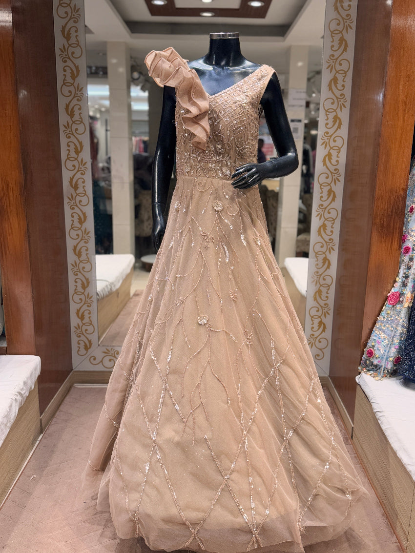 Beige evening gown on a mannequin in a store setting