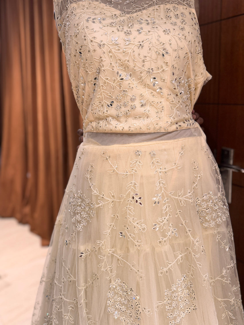 Beige embroidered dress with a plain background