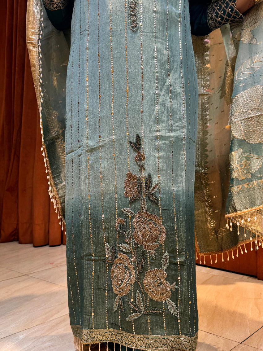 Embroidered fabric with floral patterns on a wooden surface