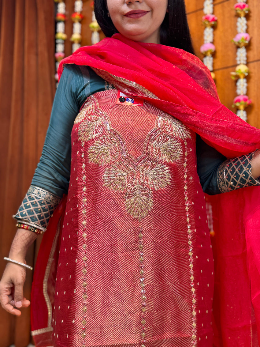 Woman wearing a red embroidered dupatta with a blurred background