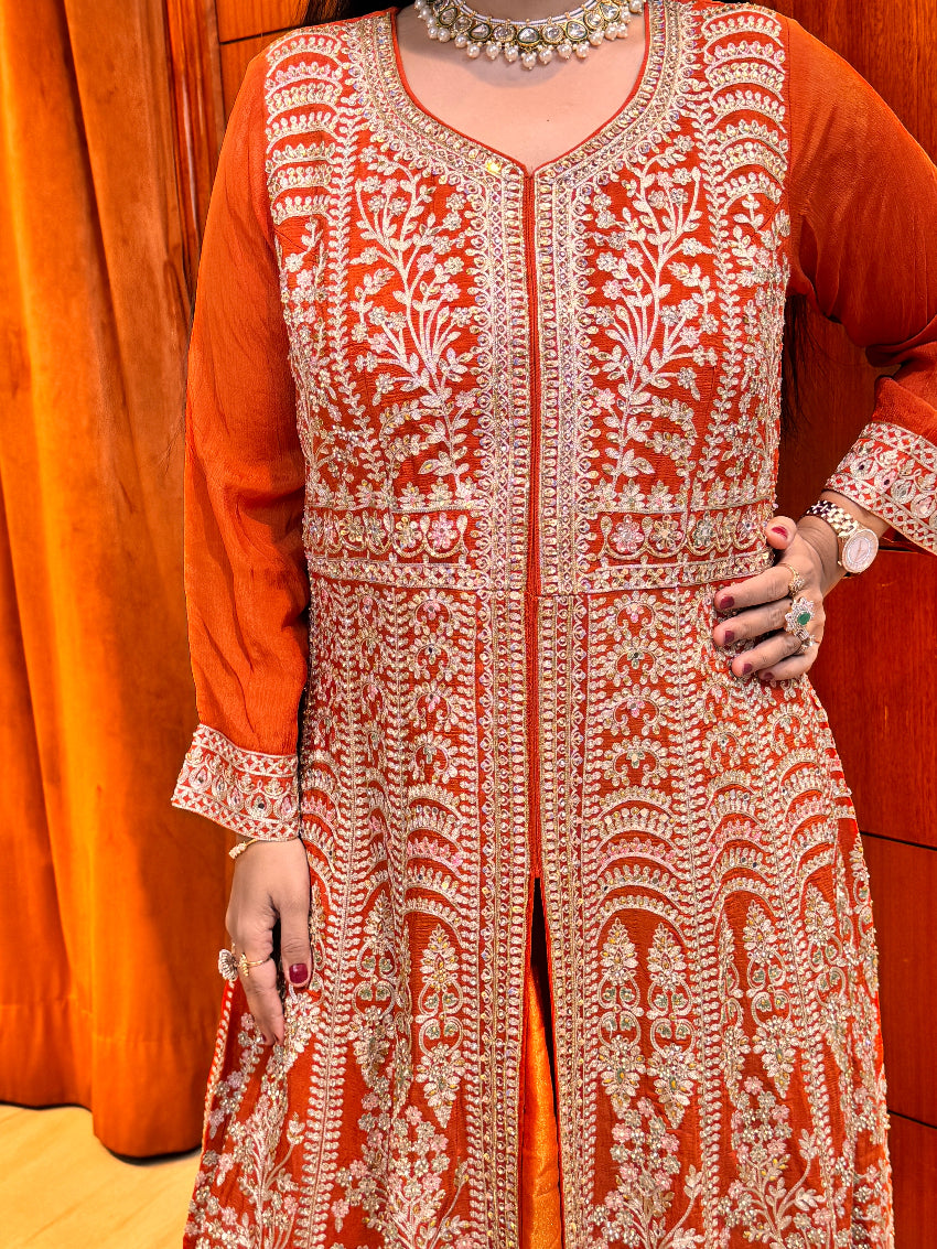 Person wearing a traditional embroidered outfit on a wooden surface