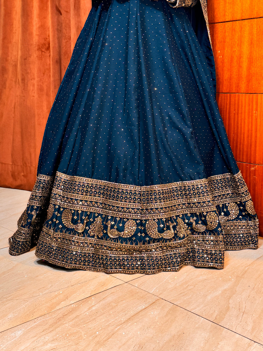 Blue saree with gold border on a wooden floor