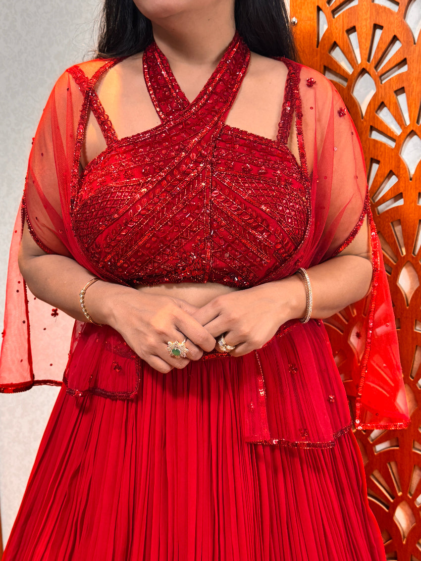 Red Sequin Halter Neck Blouse with Pleated Lehenga Skirt and Sheer Cape