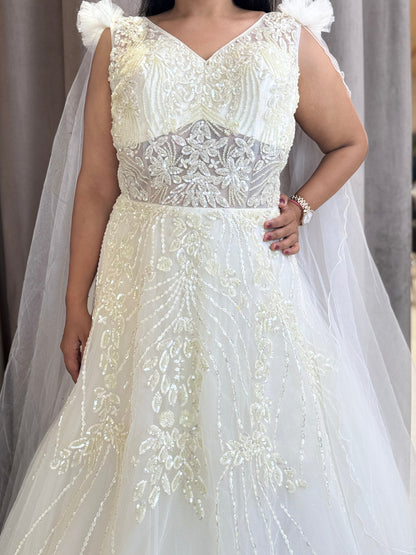 Ivory ball gown with designer hand embroidery and long net cape sleeves with frill shoulder
