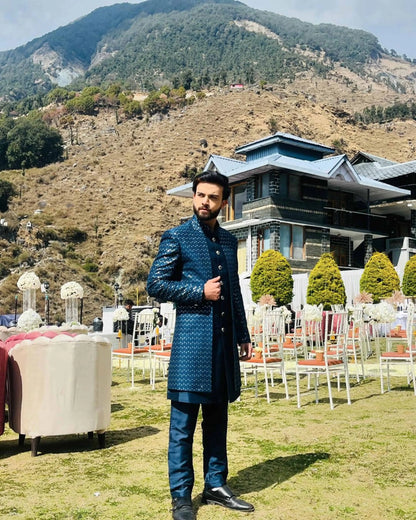 Elevate your occasion with our Peacock Blue Front Open Indo With Long Kurta, tailored for sangeet, haldi, cocktail, reception, and wedding day. Its rich hue exudes sophistication, while intricate detailing adds a touch of elegance. Designed for the modern man, this ensemble seamlessly blends tradition with contemporary style. Stand out with confidence and charm in this timeless piece, crafted to make you feel dashing and refined on your special day.